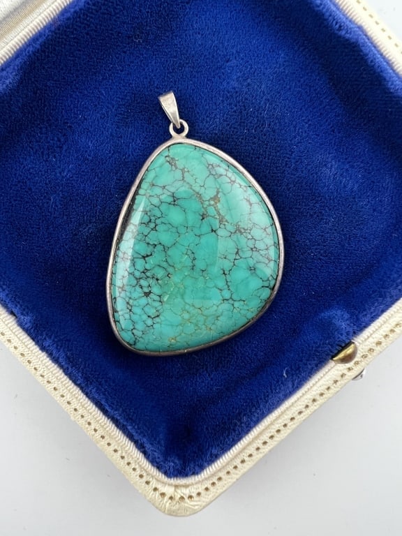 Native American Sterling Silver Turquoise Pendant: Native American Sterling Silver Turquoise Pendant. Sterling silver and turquoise necklace pendant. Measures 2 inches in length.