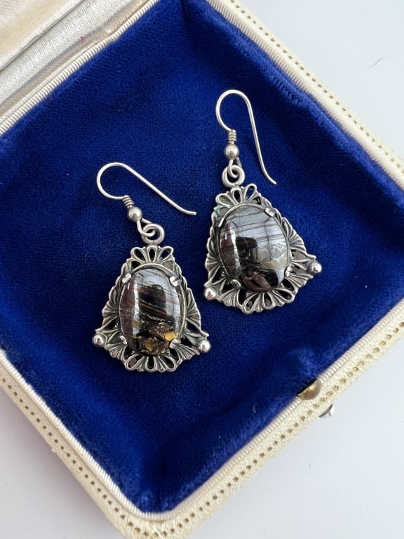 Native American Style Sterling Pietersite Earrings: Pair of Native American Style Sterling Silver & Pietersite Earrings. Cabochon opalescent stone at center possibly Pietersite or Tiger Iron. Each measures just over 1.75 inches in length.