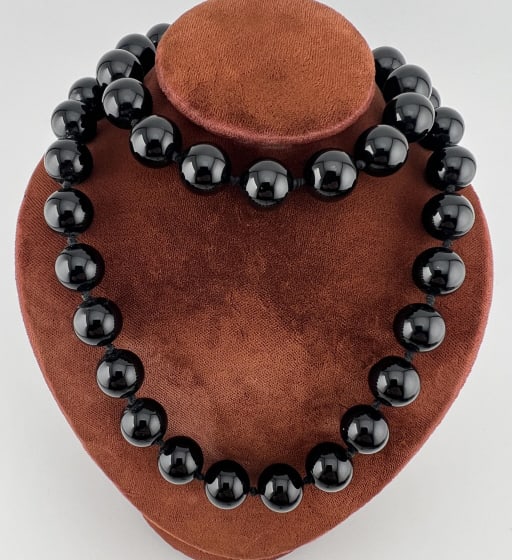 Estate Hand Knotted Black Onyx Beaded Necklace: Estate Hand Knotted Black Onyx Beaded Necklace Strand. Clasp with Chinese style calligraphy character and stamped SS. Measures approximately 24 inches in length.