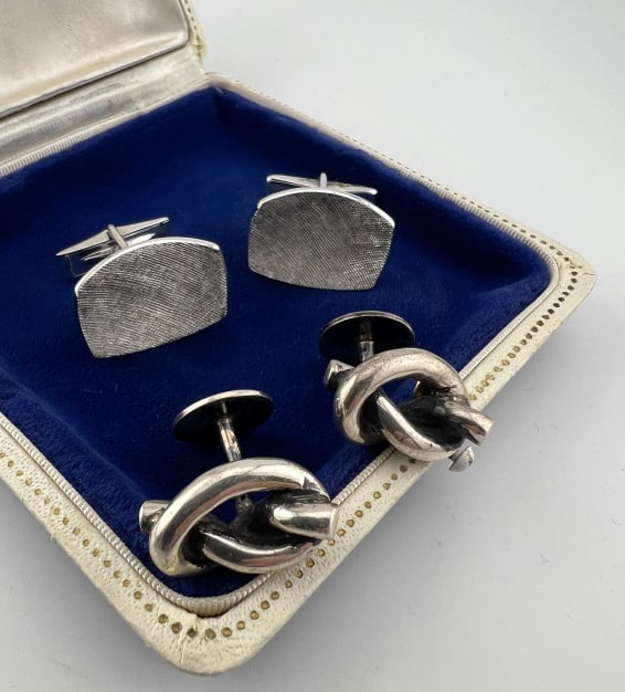 Two Pairs of Vintage Sterling Silver Cuff Links: Two Pairs of Vintage Sterling Silver Cuff Links. One pair with knot design and other with Florentine textured finish. Hallmarked. Knot pair measures just over .75 of an inch in length.