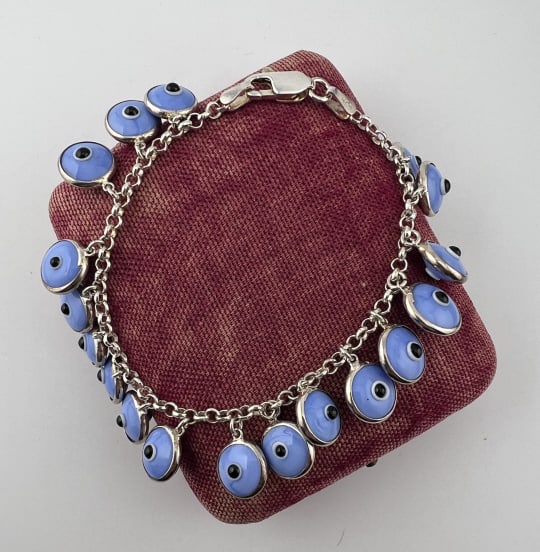 Sterling Silver Art Glass Evil Eye Charm Bracelet: Sterling Silver Art Glass Evil Eye Charm Bracelet. Hallmarked on the clasp and at the cap to the chain. Measures approximately 7.5 inches in length.