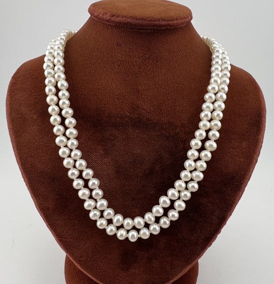 Estate 14kt Yellow Gold Two Strand Pearl Necklace: Estate 14kt Yellow Gold Double Strand Pearl Necklace. Hand knotted on white silk thread. Clasp is hallmarked. Measures nearly 18 inches in length for the longer strand.