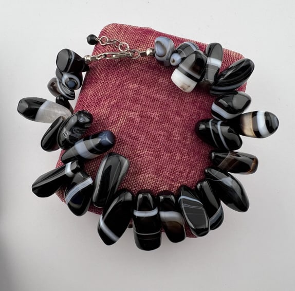 Sterling & Banded Black & White Agate Bracelet: Sterling Silver & Banded Black & White Agate Bracelet. Clasp is hallmarked. Measures nearly 9 inches in overall length can be worn at lengths from just under 8 inches to nearly 9 inches.