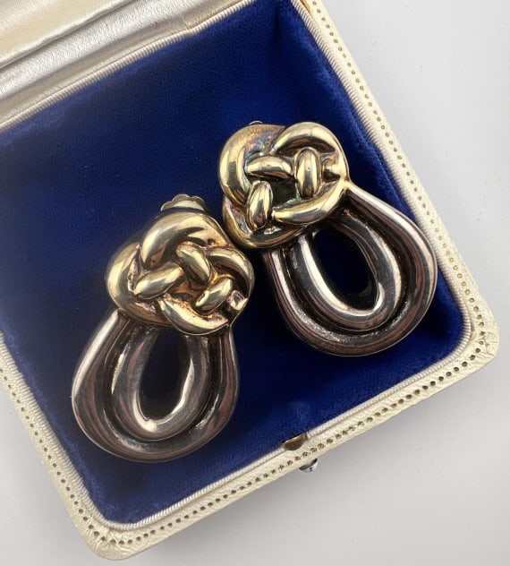 Vintage Sterling Large Scale Knot Motif Earrings: Vintage Sterling Silver Large Scale Knot Motif Earrings. Hallmarked. Clip ons. Each measures 2 inches in length. Gold wash detail at knot design.