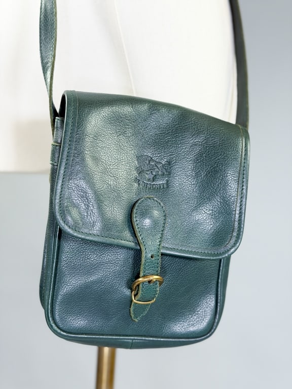 Vintage Il Bisonte Leather Cross Body Saddle Bag: Vintage Il Bisonte Leather Cross Body Saddle Bag having buckled closure with adjustable strap. Measuring approximately 6 inches by 8 inches by 2.5 inches. General wear as shown throughout.