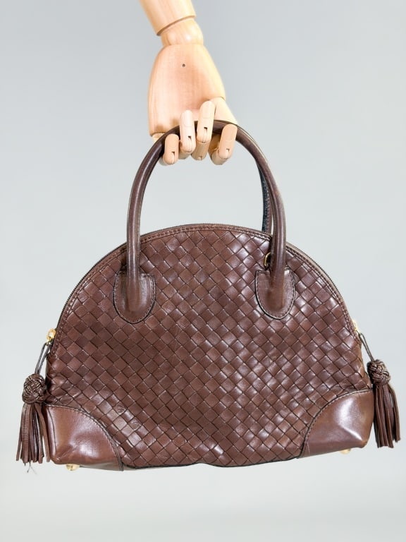 Vintage Bottega Veneta Intrecciato Leather Bag: Vintage Bottega Veneta Intrecciato Leather Bowler Bag Purse having zip top closure with leather tassel details. Measuring approximately 12 inches by 9 inches by 3 inches. General wear as shown through