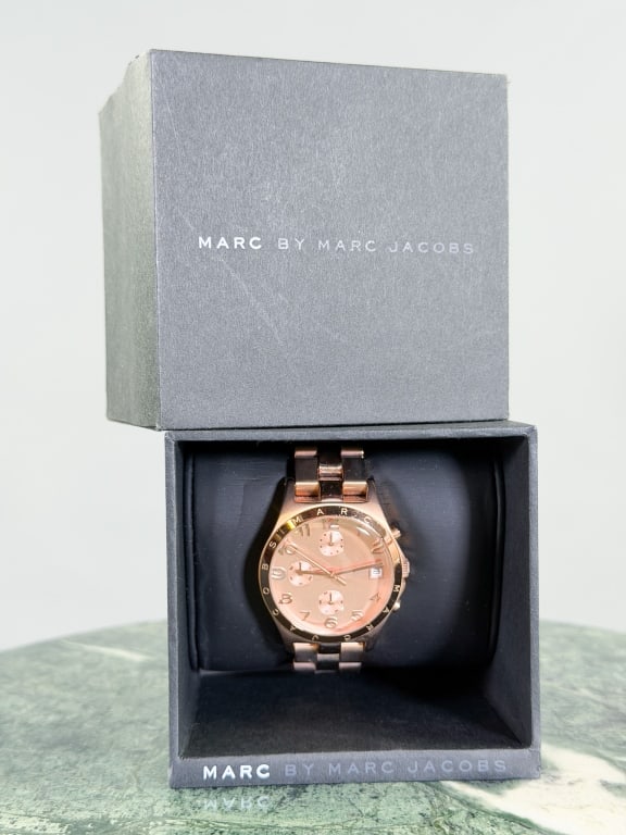 Vintage Marc by Marc Jacobs Rose Gold Tone Watch: Vintage Marc by Marc Jacobs Henry Rose Gold Tone Watch measuring approximately 1.5 inches across dial. General wear as shown throughout. Comes with original box.
