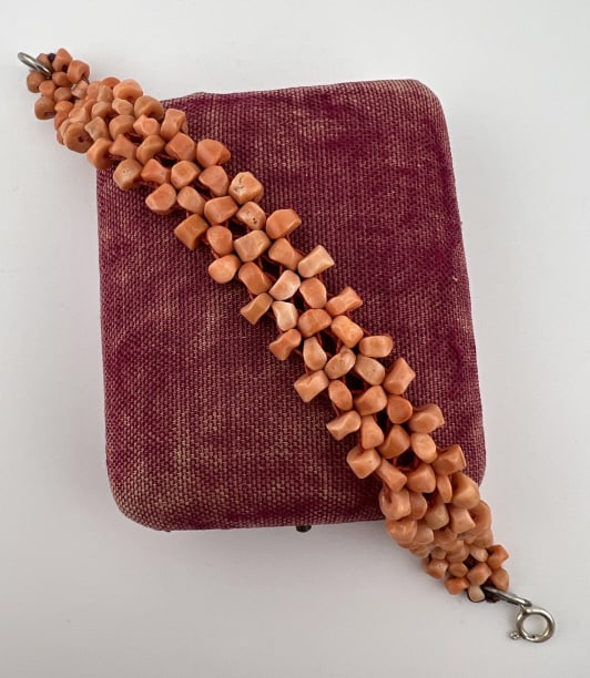 Estate Antique Coral Bead Bracelet Sterling Clasp: Estate Antique Woven Coral Beaded Bracelet w Sterling Silver Clasp. Clasp is hallmarked. Measures 7.25 inches in length.
