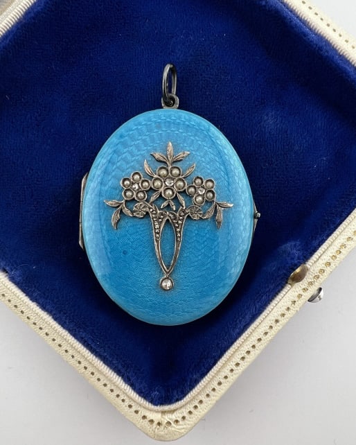 Antique Guilloche Enamel & Diamond Locket: Antique Guilloche Enamel & Diamond Locket. Antique silver locket with blue guilloche enamel, seed pearls and four rose cut diamond accents. Floral gardinetto motif on the front. Measures nearly 2.25 i