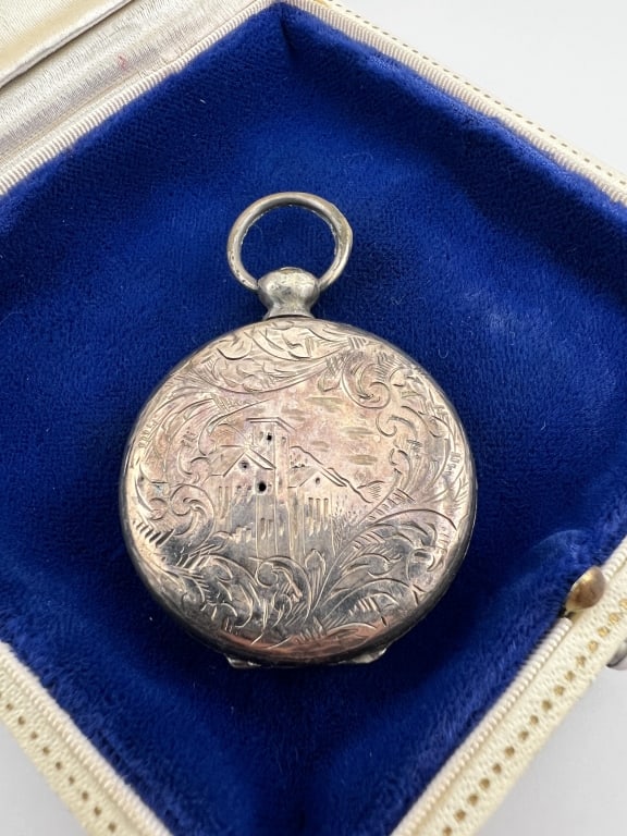Antique 19th C Silver Locket Necklace Pendant: Antique 19th C Silver Locket Necklace Pendant. Chased on one side with pastoral scene of a castle, other side with scrollwork / foliage. Measures approximately 2 inches in length.