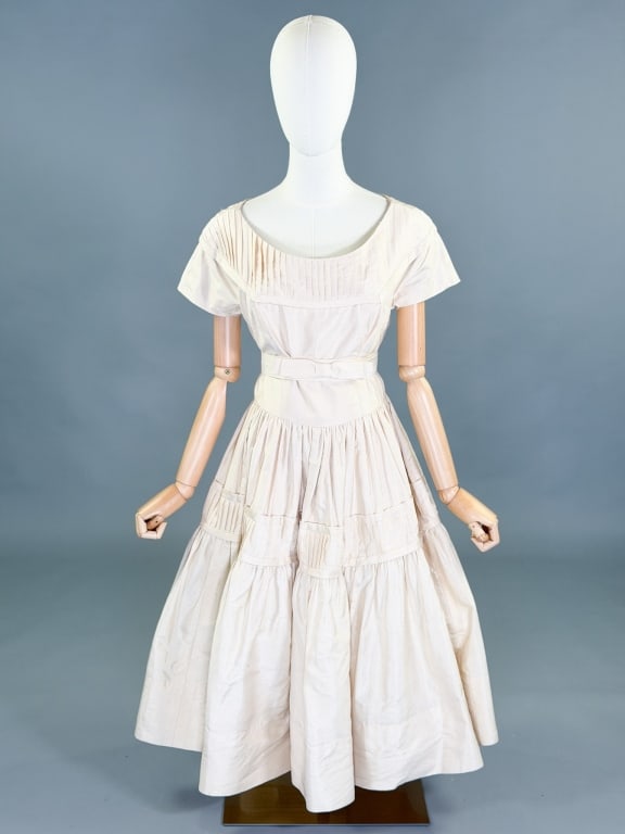 Vintage 1950s Silk Cocktail Dress: Vintage 1950s Silk Cocktail Dress having center back zip closure and pleated details throughout. Measuring 36 inch bust, 30 inch waist, 43 inches long. General wear as shown throughout.