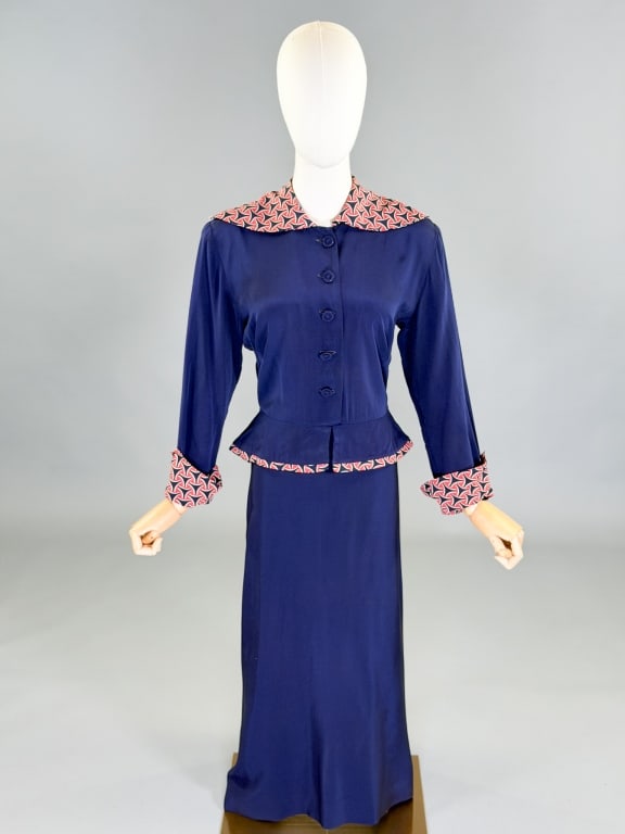 Vintage 1940s Rayon Printed Peplum Dress: Vintage 1940s Rayon Printed Peplum Dress having button front and back zip closure. Measuring 40 inch bust, 28 inch waist, 47 inches long, 20 inch sleeve length. General wear as shown throughout.