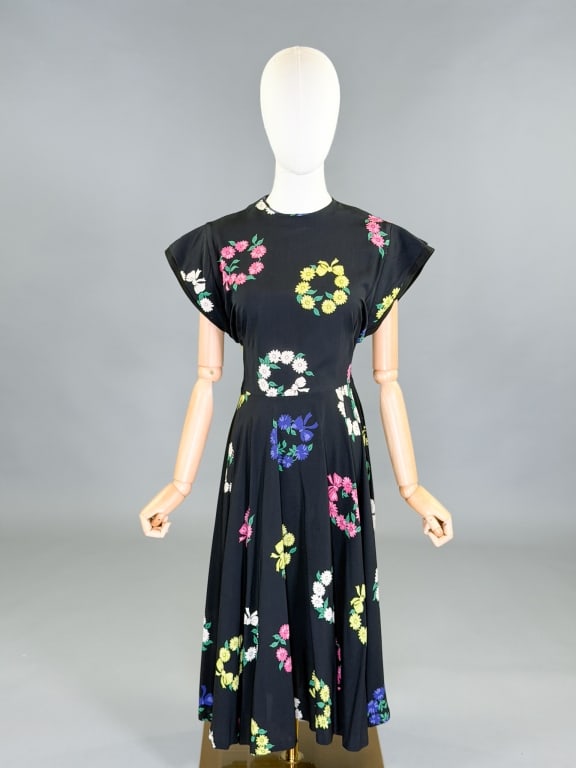 Vintage 1940s Floral Print Day Dress: Vintage 1940s Floral Print Day Dress having back zip closure and floral print throughout. Measuring 34 inch bust, 26 inch waist, 45 inches long, 4 inch sleeve length. General wear as shown throughout.