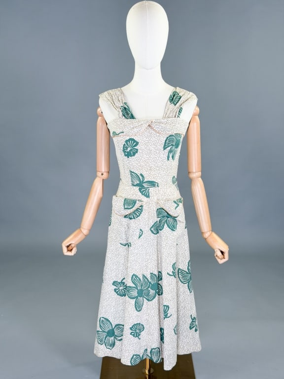 Vintage 1950s Cotton Printed Day Dress: Vintage 1950s Cotton Printed Day Dress having back zip closure and two front pockets. Measuring 34 inch bust, 25 inch waist, 44 inches long. General wear as shown throughout.
