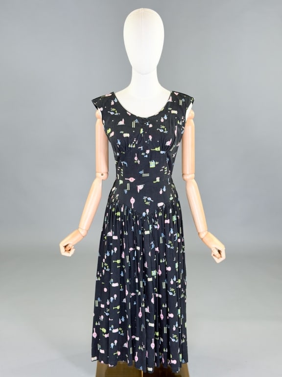 Vintage 1950s Cotton Novelty Print Day Dress: Vintage 1950s Cotton Novelty Print Day Dress having back zip closure and rhinestone details at neck. Measuring 34 inch bust, 26 inch waist, 44 inches long. General wear as shown throughout.