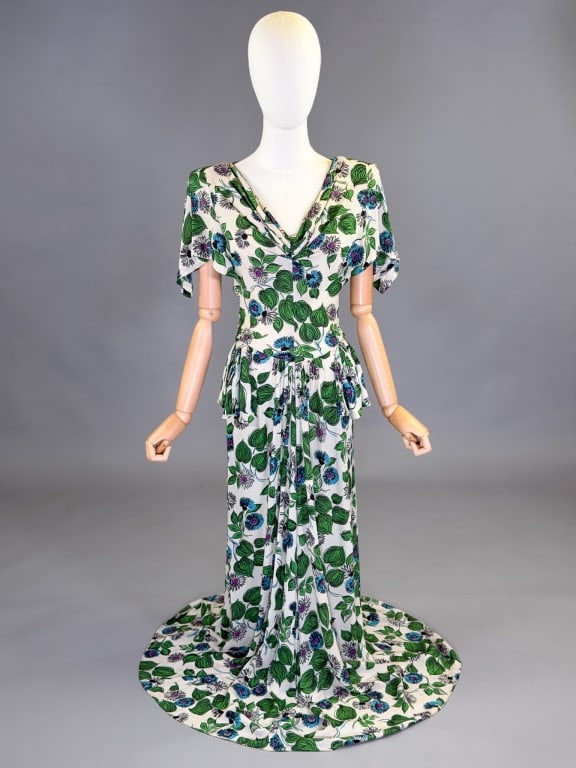 Vintage 1940s Floral Print Crepe Gown Dress: Vintage 1940s Floral Print Crepe Gown Dress having pleated detail at front with fluttered sleeves and side zip closure. Measuring 36 inch bust, 26 inch waist, 58 inches long, 12 inch sleeve length. Ge