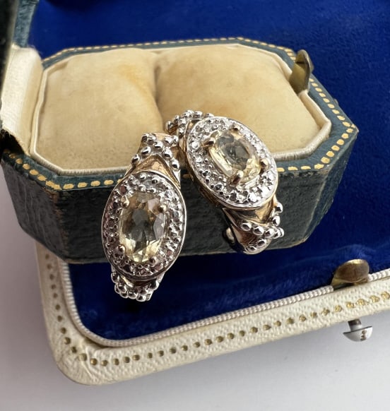 Pair Citrine & Diamond Sterling Silver Earrings: Pair Citrine & Diamond Sterling Silver Earrings. Hallmarked. Each set with an oval citrine and diamond accents. Each measures just under .75 of an inch in length.