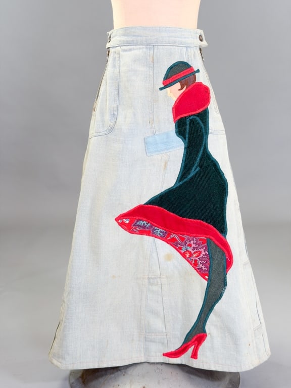 Vintage 1970s Figural Patchwork Denim Jean Skirt: Vintage 1970s Figural Patchwork Denim Jean Skirt having zip closure and patchwork figure at front with back pockets. Measuring 24 inch waist, 30 inches long.