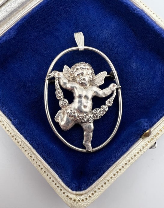 Vintage Sterling Silver Cherub Necklace Pendant: Vintage Sterling Silver Cherub Necklace Pendant. Can be worn as a necklace pendant or a brooch. Hallmarked on back of pendant and also on the bail. Measures 2.25 inches in length with the bail.