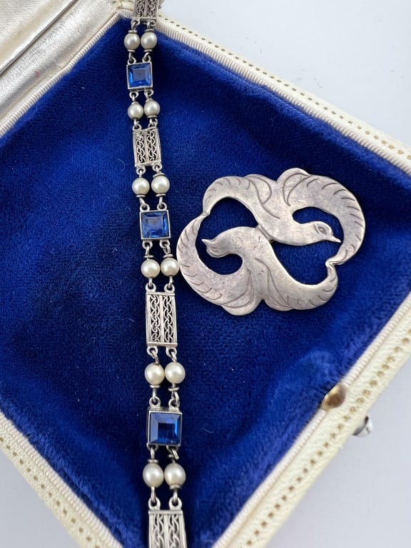 Art Deco Sterling & Sapphire Bracelet w Charm: Antique Art Deco Sterling & Sapphire Bracelet w Charm. Antique sterling silver bracelet with synthetic blue sapphires and pearl accents together with a sterling silver Art Deco / modernist design