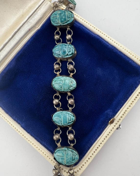 Antique Egyptian Revival Silver & Scarab Bracelet: Antique Egyptian Revival Silver & Scarab Bracelet. Articulated panel bracelet featuring eight faience scarabs in a turquoise blue color. Clasp is hallmarked 925 for sterling, bracelet otherwise unmark