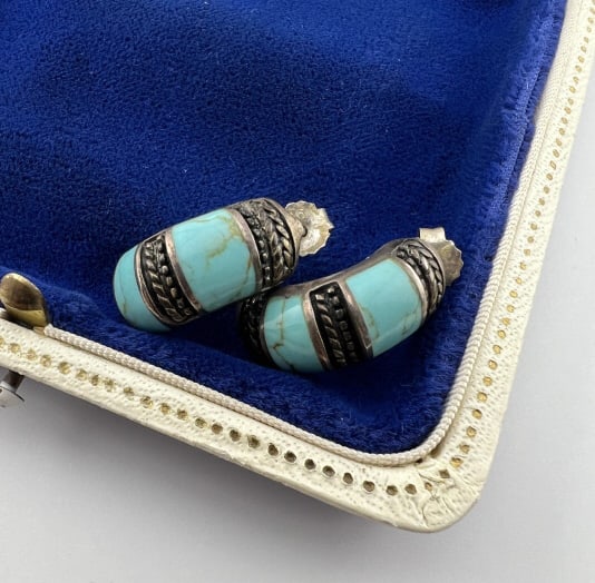 Native American Sterling & Turquoise Earrings: Pair of Native American Sterling Silver & Turquoise Earrings. Native American style / design each set with two turquoise panels. Hallmarked. Each measures approximately .75 of an inch in length.