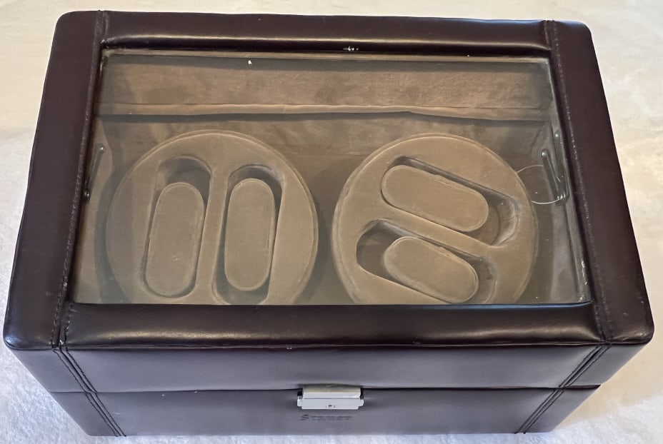 Automatic Watch Winder Rotator Jewelry Box: Automatic Watch Winder Rotator Jewelry Box. Electric. Interior with holders for four watches. Glass panel on front. Leather exterior. Measures approximately 8 x 13 x 8 inches.