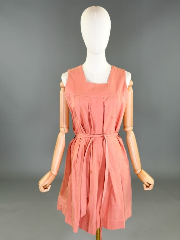 Vintage 1940s Pleated Uniform Pinafore Dress: Vintage 1940s Pleated Uniform Pinafore Dress having no closure, slides over head. Measuring 38 inch bust, 40 inch waist, 35 inches long. With belt at waist. General wear and spots throughout as shown.