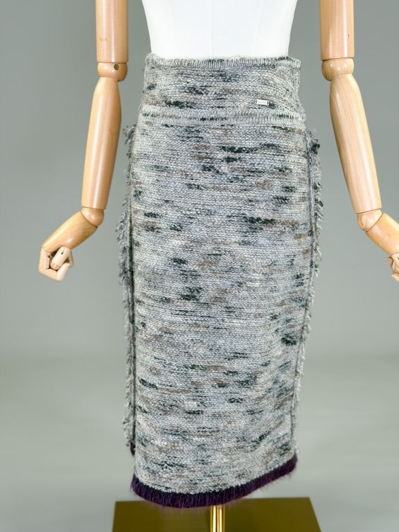 Vintage 1999 Chanel Wool Knit Skirt: Vintage 1999 Chanel Wool Knit Skirt having stretch throughout. Marked size 34. Measuring 26-32 inch waist, 28 inches long. From the lifetime collection, fashion archive and business inventory of colle