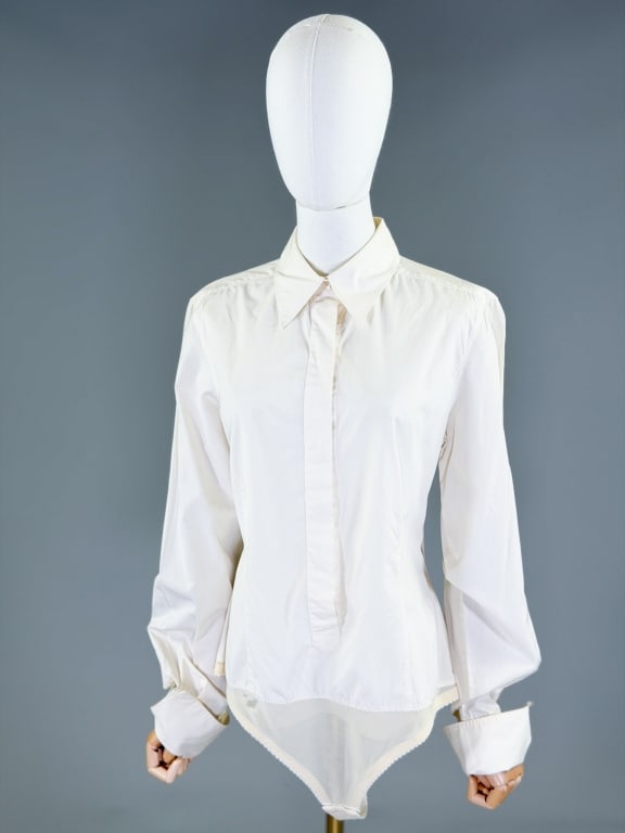 Vintage 1990s Jean Paul Gaultier Bodysuit Shirt: Vintage 1990s Jean Paul Gaultier Bodysuit Shirt having covered placket button front closure with snap crotch bodysuit detail. Labeled Jean Paul Gaultier Femme. Measuring 42 inch bust, 38 inch waist, 3
