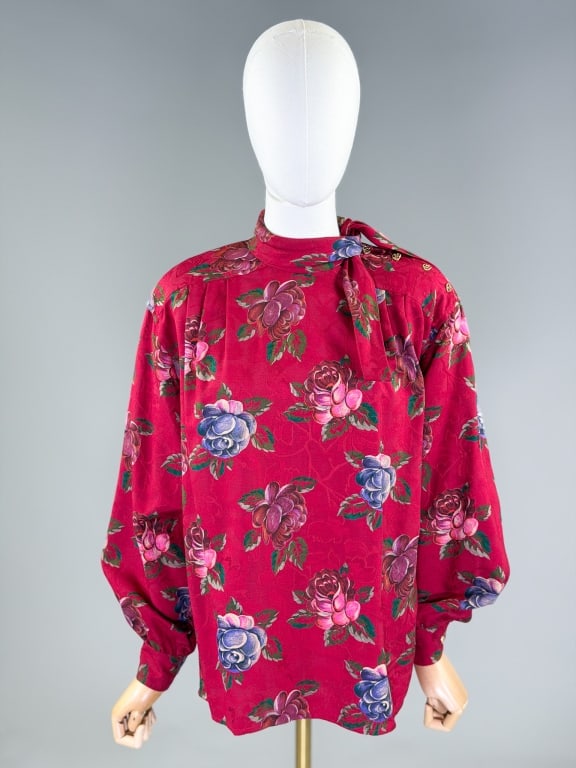 Vintage 1980s Emanuel Ungaro Cotton Floral Blouse: Vintage 1980s Emanuel Ungaro Cotton Floral Blouse having tie collar with buttons at shoulder. Labeled Ungaro Ter, marked size 44/10. Measuring 50 inch bust, 27 inches long, 23 inch sleeve length. From