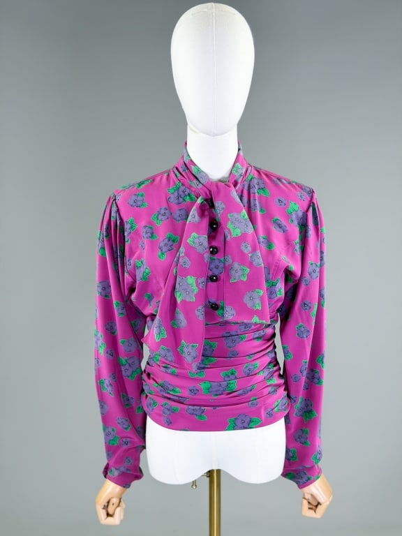 Vintage 1980s Emanuel Ungaro Silk Floral Blouse: Vintage 1980s Emanuel Ungaro Silk Floral Blouse having pussy bow tie at neck with button front and side zip closure. Labeled Ungaro Ter, marked size 42/8. Measuring 38 inch bust, 26-28 inch waist, 28 