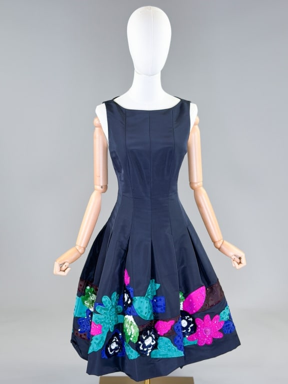 Vintage Oscar de la Renta Sequin Cocktail Dress: Vintage Oscar de la Renta Silk Floral Sequin Cocktail Dress having sleeveless armholes and pleated skirt with applique floral sequin details at hem, closing at center back with zip. Labeled Oscar de l