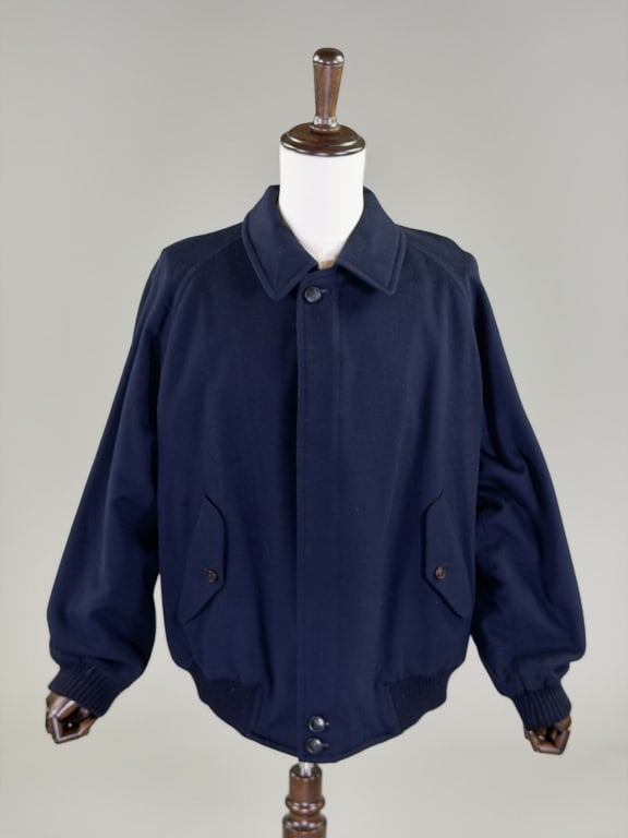 Vintage 1990s Burberry's Wool Bomber Jacket Coat: Vintage 1990s Burberry's Wool Bomber Jacket Coat having zip and button front closure with two front buttoned pockets, fully lined. Labeled Burberry's. Measuring 54 inch chest, 28 inches long, 28 inch 