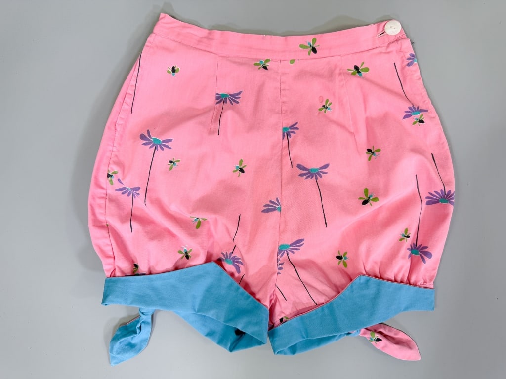 Vintage 1950s Cotton Novelty Print Shorts: Vintage 1950s Cotton Novelty Print Shorts having side button closure with tie detail at cuffs. Measuring 24 inch waist, 14.5 inch rise, 15 inch total length. General wear as shown throughout. From the