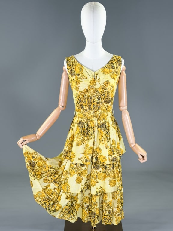 Vintage 1950s Cotton Floral Tiered Dress: Vintage 1950s Cotton Floral Tiered Dress having center back zip closure. Measuring 36 inch bust, 26 inch waist, 43 inches long. General wear as shown throughout. From the lifetime collection, fashion 