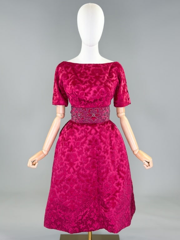 Vintage 1950s Whitney Velvet Beaded Cocktail Dress: Vintage 1950s Whitney Velvet Beaded Cocktail Dress having boat neckline with short sleeves, beaded belt at waist, and low scoop back neckline with center back zip closure and crinoline in skirt. Label
