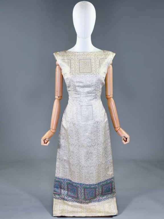 Vintage 1960s Catherine Scott Lame Wiggle Dress: Vintage 1960s Catherine Scott Lame Wiggle Dress having boat neckline with low cut back and center back zip closure, fully lined throughout. Labeled Catherine Scott. Measuring 34 inch bust, 28 inch wai