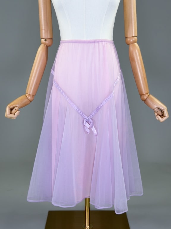 Vintage 1960s Vanity Fair Nylon Knit Ribbon Skirt: Vintage 1960s Vanity Fair Nylon Knit Ribbon Skirt having satin ribbon detail and layers of sheer nylon with elastic waist. Labeled Vanity Fair - marked size Small. Measuring 24 - 36 inch waist, 26 inc
