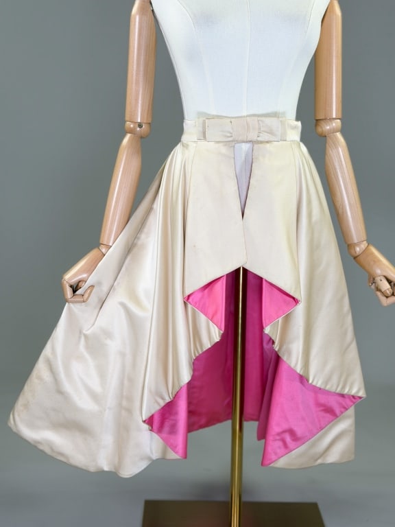 Vintage 1960s Silk Satin Draped Over Skirt Bottom: Vintage 1960s Silk Satin Draped Over Skirt Bottom having bow at center front with hook and snap closures, contrast pink lining. Measuring 30 inch waist, 27 inches long. General wear and spots as shown