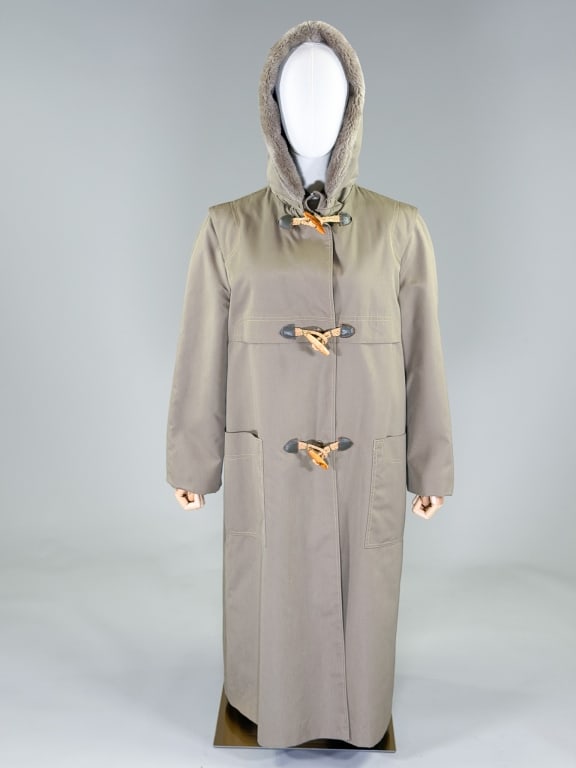 Vintage 1970s Bonnie Cashin Trench Rain Coat: Vintage 1970s Bonnie Cashin Trench Rain Coat having removable hood at neck with snap and toggle closures at center front, two front pockets. Fully lined. Labeled Bonnie Cashin, Weatherwear for Russ Ta