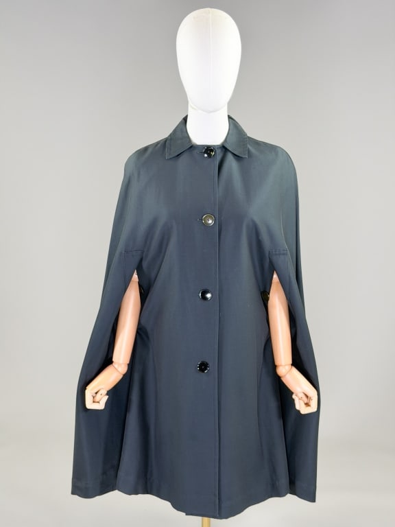 Vintage 1960s Bonwit Teller Cape Coat Shawl Wrap: Vintage 1960s Bonwit Teller Cape Coat Shawl Wrap having button front closure with two buttoned arm holes. Labeled Bonwit Teller. Measuring one size fits most, 38 inches long. From the lifetime collect