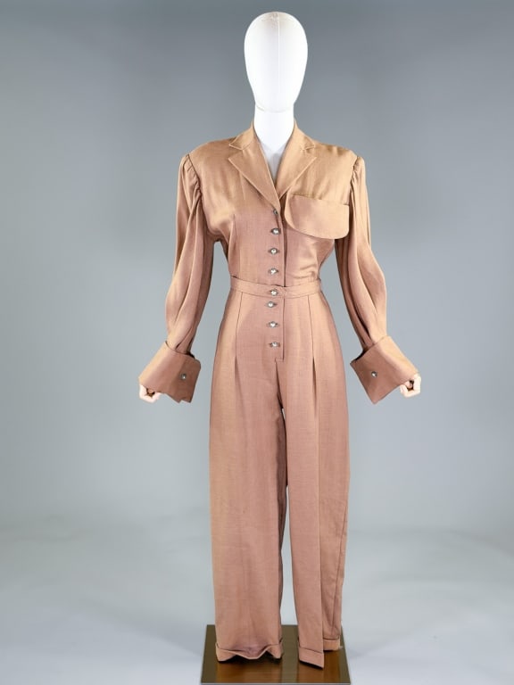 Vintage 1960s Linen Button Front Jumpsuit Coverall: Vintage 1960s Linen Button Front Jumpsuit Coverall having button front closure with single breast pocket and belt at waist. Labeled De Pinna Fifth Avenue New York. Measuring 36-40 inch bust, 30 inch w