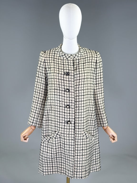 Vintage 1960s Galanos Wool Window Pane Swing Coat: Vintage 1960s Galanos Wool Window Pane Swing Coat having rounded neckline with button front closure and two front pockets, fully lined. Labeled Galanos. Measuring 40 inch bust, 38 inch waist, 36 inche