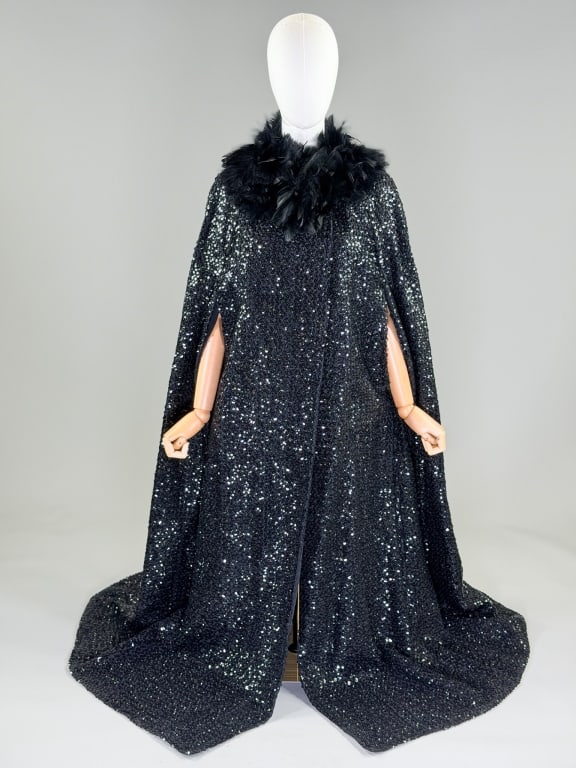 Vintage 1960s Feather Sequin Cape Cloak: Vintage 1960s Feather Sequin Cape Cloak having feathered collar with snap closure at neck and two front armholes. Measuring one size fits most, 56 inches long. From the lifetime collection, fashion ar