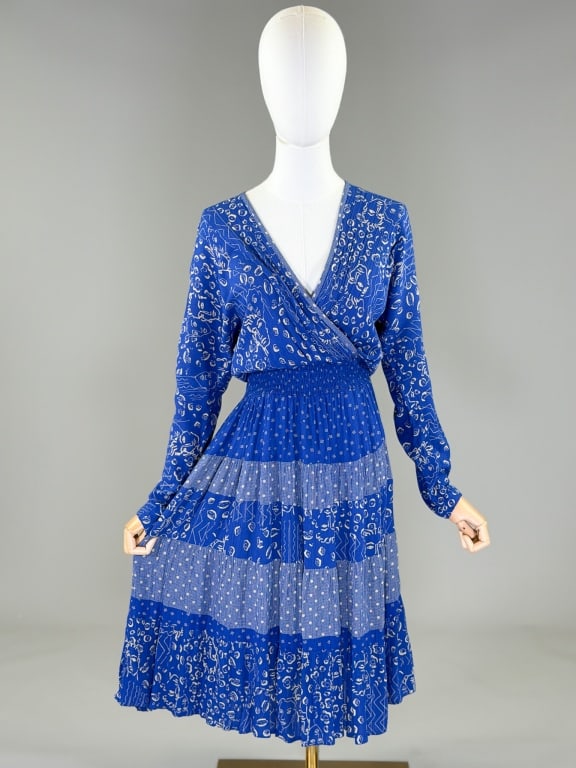 Vintage 1970s Rayon Novelty Face Print Day Dress: Vintage 1970s Rayon Novelty Face Print Day Dress having wrap v-neckline with elastic waist, tiered skirt, and dolman sleeves. Measuring 32 - 40 inch bust, 22 - 40 inch waist, 44 inches long, 19 inch s
