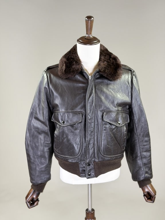 Vintage 1970s Leather Faux Fur A 2 Flight Jacket: Vintage 1970s Leather Faux Fur A 2 Flight Jacket having zip front closure with faux fur collar and lining, two front pockets and ribbed hem and sleeve cuffs. Measuring 44 inch chest, 38 inch waist, 24