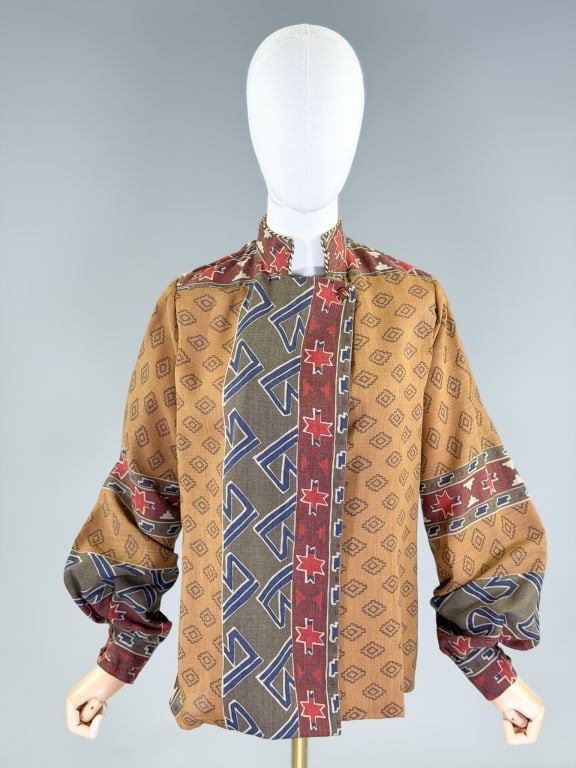Vintage 1970s Southwestern Print Blouse Top: Vintage 1970s Southwestern Print Blouse Top having button at neck and tie at waist with sailor collar detail at back. Labeled Joseph Piselli for Bal Degrace. Measuring free bust, 25 inches long, 27 in