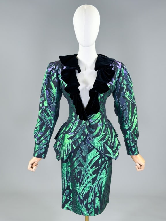 Vintage 1980s Emanuel Ungaro Lame Skirt Suit: Vintage 1980s Emanuel Ungaro Lame Skirt Suit with jacket having ruffled velvet collar, closing at front with single breasted button closure, fitted through body with peplum at side waist. Skirt closin