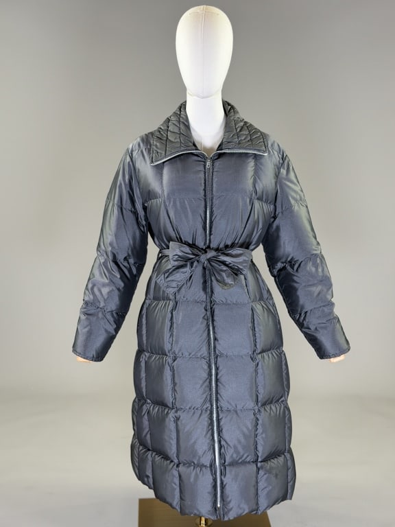 Vintage 1980s Comfy Goose Down Quilted Puffer Coat: Vintage 1980s Comfy Goose Down Silver Quilted Puffer Coat having zip front closure with belt at waist and two side pockets. Labeled Comfy. Measuring 46 inch bust, 44 inch waist, 42 inches long, 23 inc